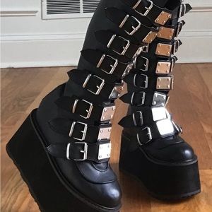Black knee high boots with chrome buckles